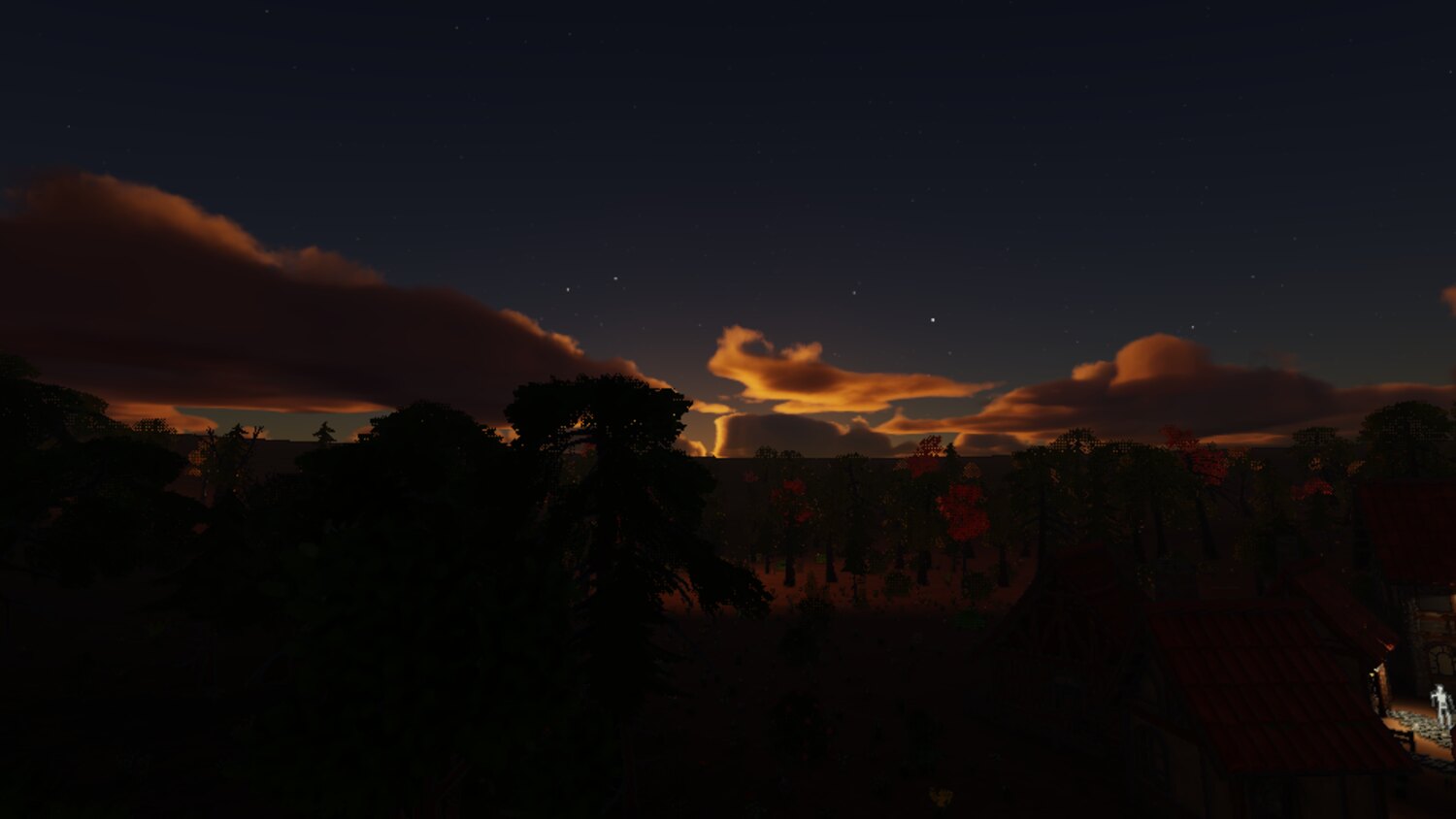 a red and gold sunset over a dark treeline